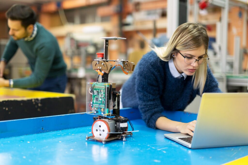 Young Woman Engineer Working On Robotics Project